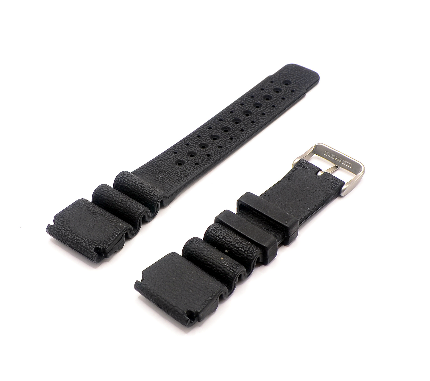 Close-up of a 24mm black rubber watch strap, displaying the textured surface and the stainless steel buckle. The strap is laid out flat to show its flexible design and sturdy build.