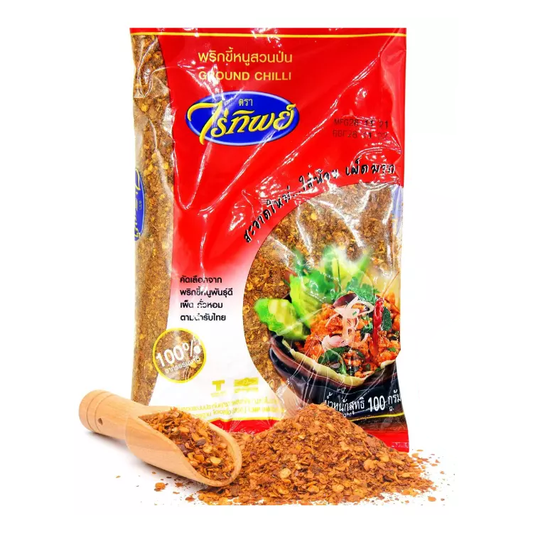 A 100g pack of Raitip Ground Red Thai Chilli with a wooden scoop spilling chilli flakes, showcasing its premium quality and spicy flavour.