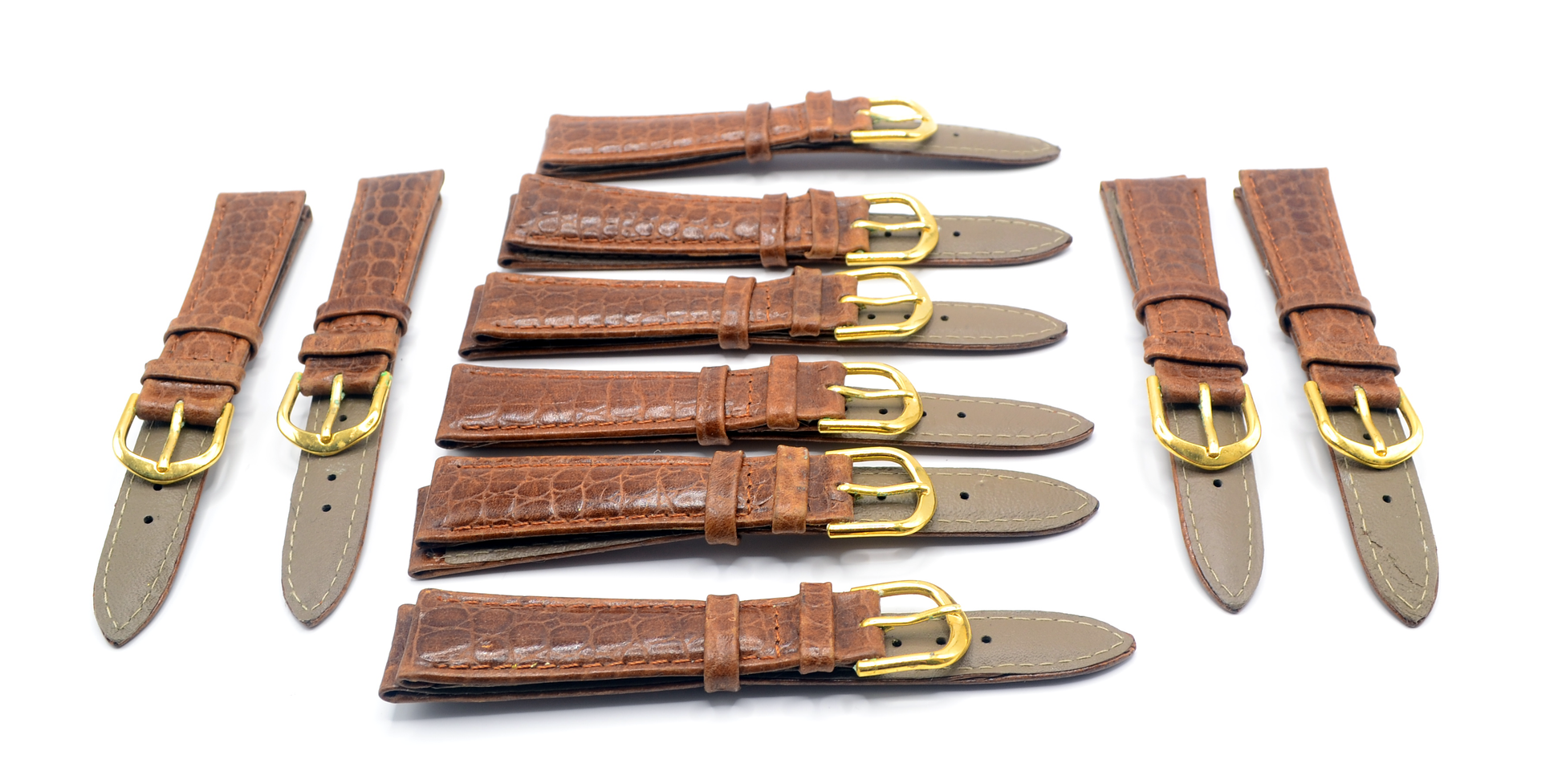 Close-up view of individual brown leather watch straps with gold-tone buckles, highlighting the crocodile texture.