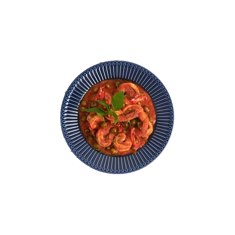 A vibrant Panang curry with prawns, Thai basil, and red chillies, served on a blue ceramic plate.