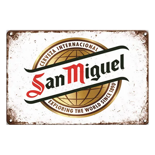 San Miguel Cerveza Internacional Vintage Wall Sign featuring the iconic logo and tagline "Exploring the World Since 1890" on a distressed white background, perfect for home bars and pubs.