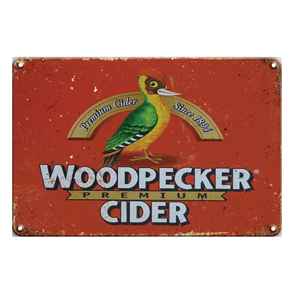 Woodpecker Premium Cider vintage wall sign featuring a vibrant red background with the Woodpecker logo, perfect for pubs, home bars, or man caves.