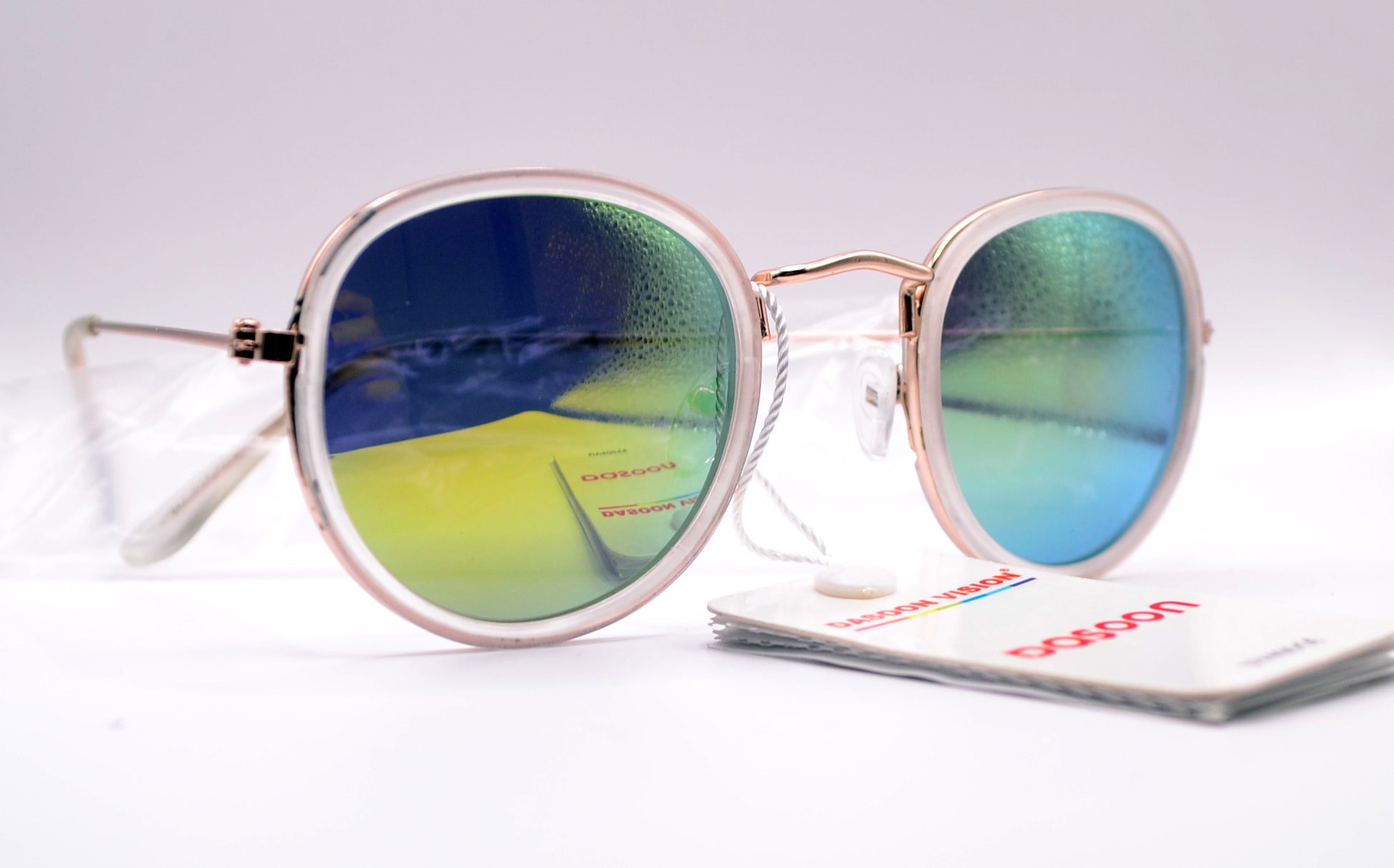 Close-up of round mirrored sunglasses with a rose gold frame and green-blue reflective lenses, labeled "Dasoon Vision" with UV400 protection tag attached.