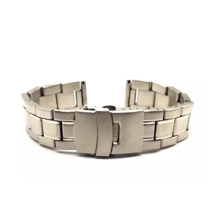 Stainless steel watch strap with clasp closed - side view.